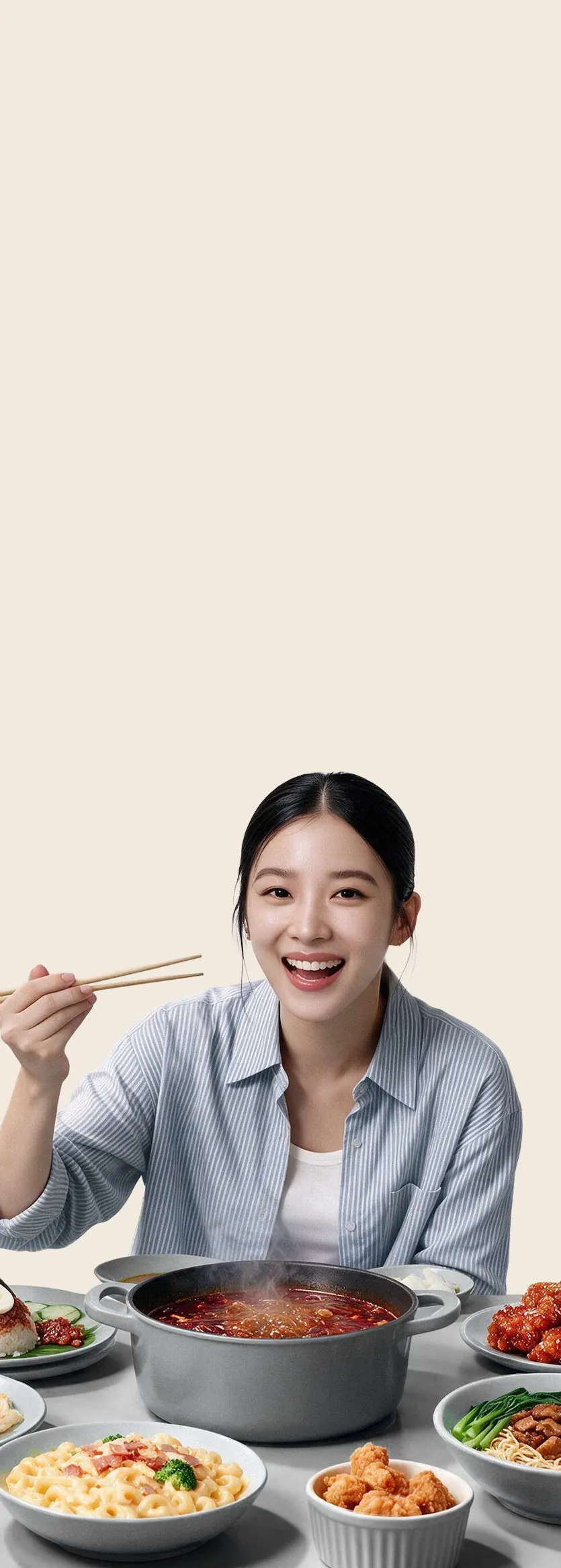 A woman at a table full of takeaway food and dishes, happily raising her chopsticks