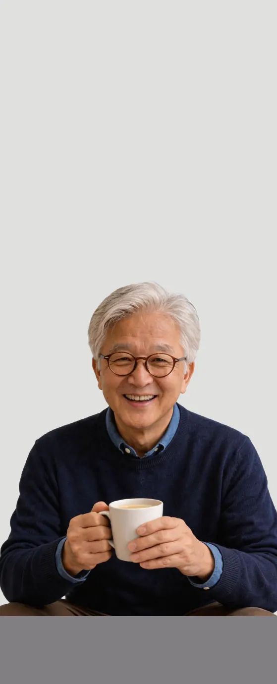 戴眼镜的银发长者双手捧着一杯热饮,开心地微笑